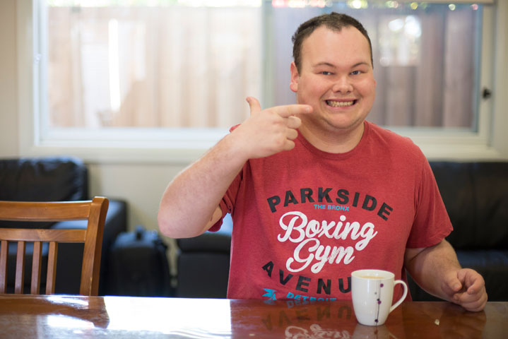 Civic client, Nick, enjoying a cup of tea while smiling.