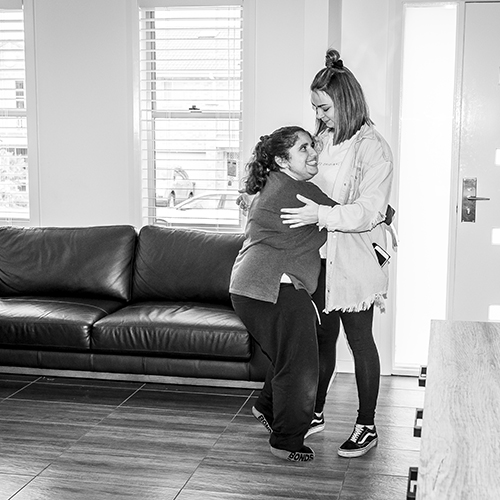 Civic Assisted Living staff hugging a client