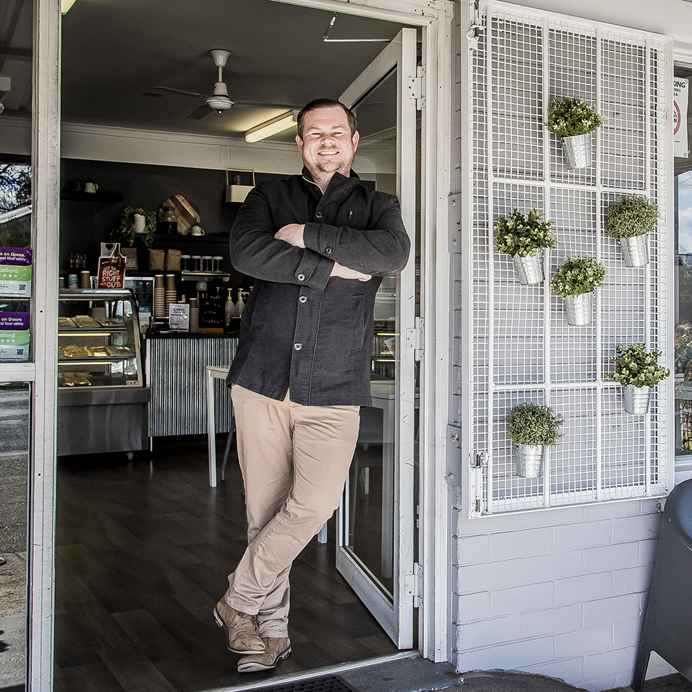 Civic Kitchen & Catering cafe owner posing in cafe door