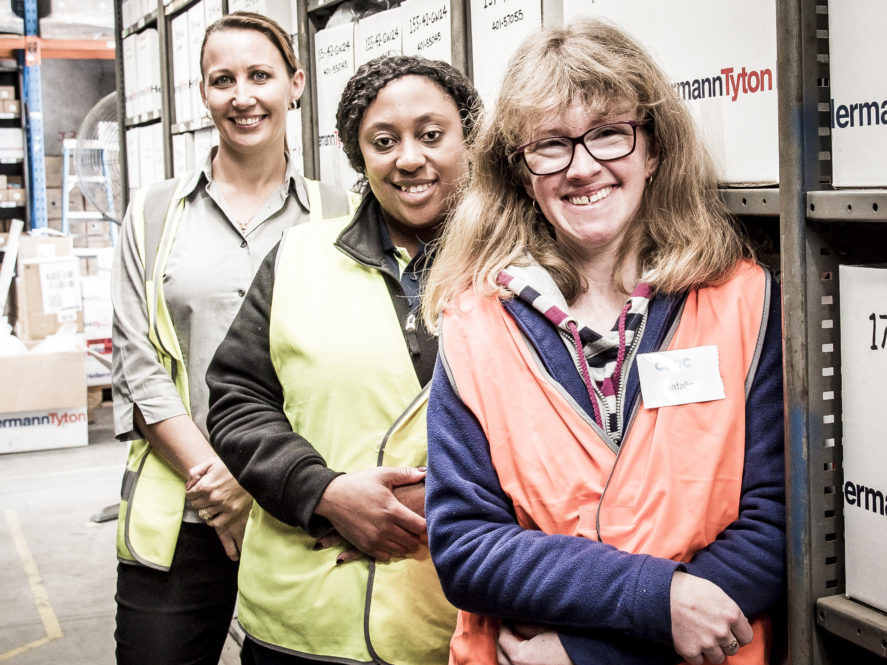 Civic Warehousing and Mailing staff posing for a picture dressed in their high vis vests