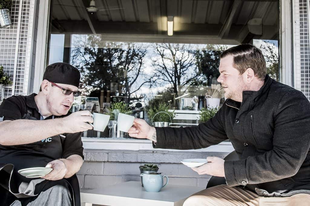 staff member enjoying a coffee with a client at Civic Café Nowra