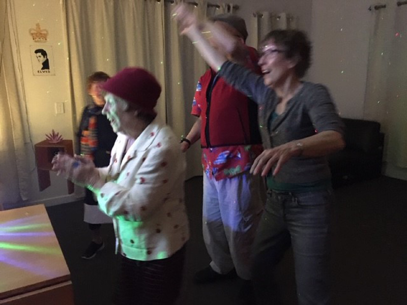 Civic@Home disco night in the Blue Mountains' living room, with music and colourful disco lights on to set the scene
