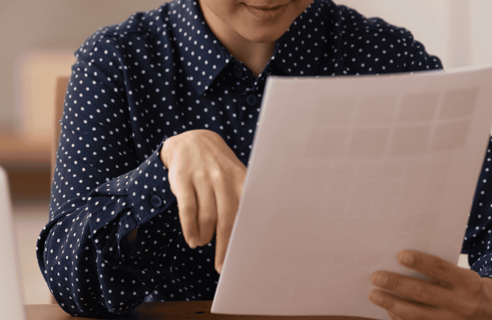 A LADY LOOKS AT A DOCUMENT